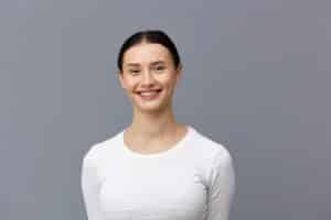 Young attractive woman smiles, still pleased with her breast augmentation results five years after her surgery.